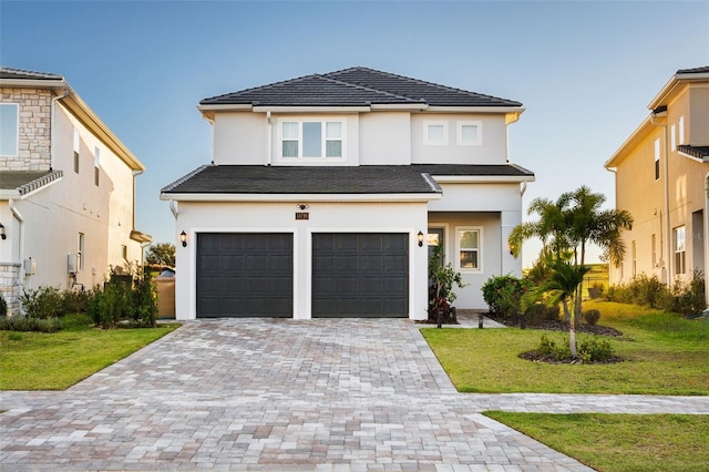 view of front of property featuring a front yard and a garage