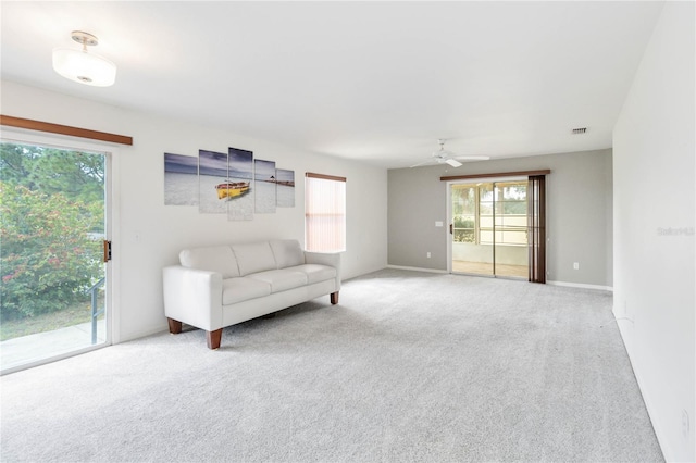 unfurnished living room featuring ceiling fan and carpet floors