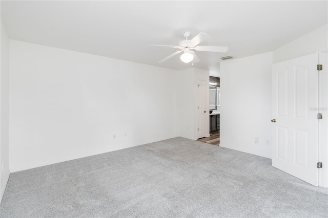 empty room featuring light carpet and ceiling fan