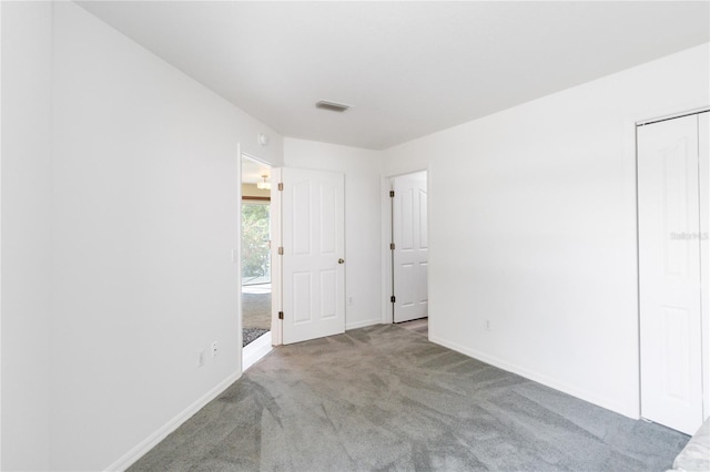 spare room featuring light colored carpet