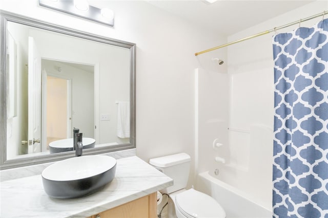 full bathroom featuring shower / bath combo, vanity, and toilet