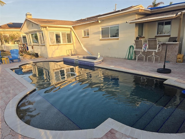 view of pool with an in ground hot tub and a patio area