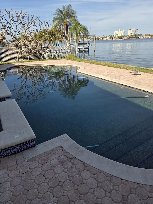 view of swimming pool with a water view and a patio