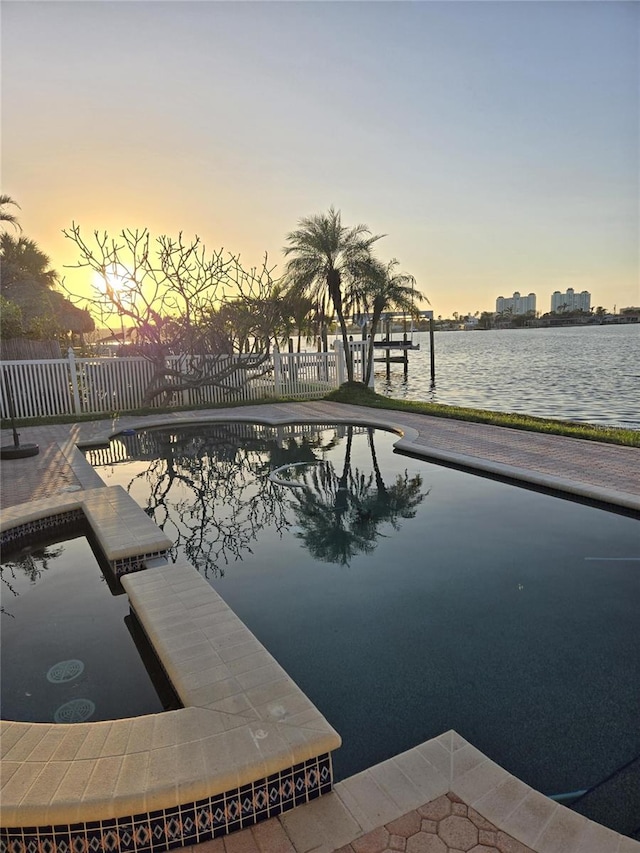 pool at dusk with a water view