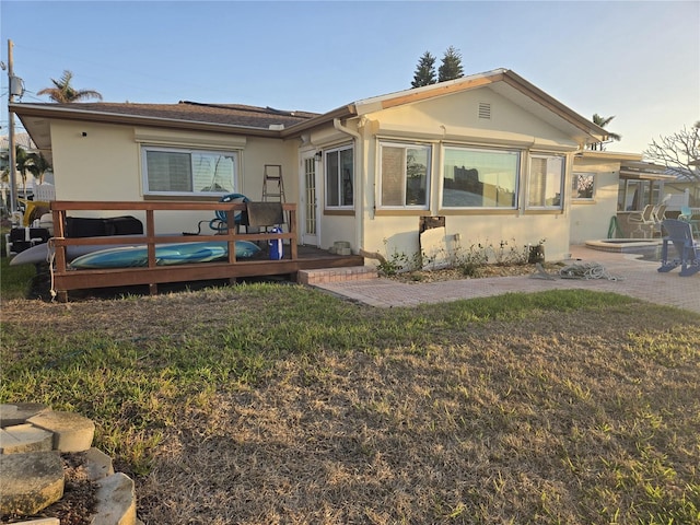 rear view of house featuring a yard