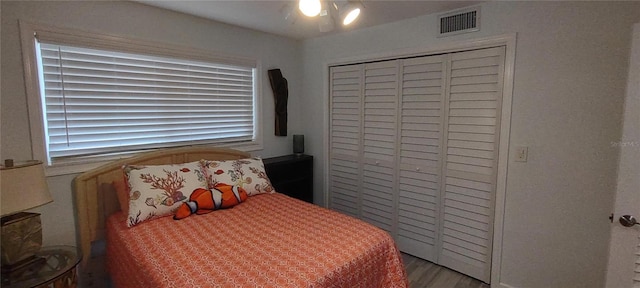 bedroom featuring hardwood / wood-style flooring and a closet