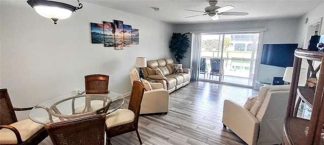 living room with ceiling fan and light wood-type flooring