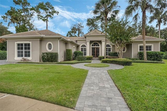 mediterranean / spanish house featuring a front lawn