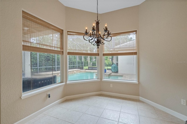 unfurnished dining area featuring a chandelier and tile patterned flooring