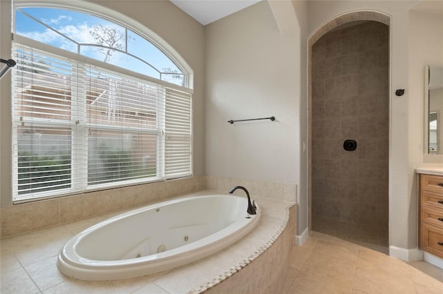 bathroom with vanity, tile patterned floors, and plus walk in shower