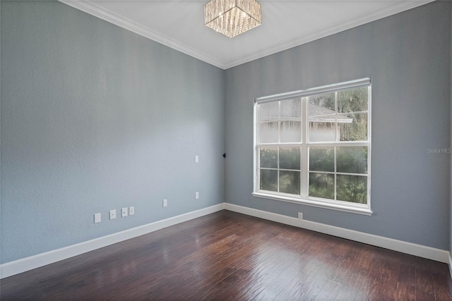 empty room with dark hardwood / wood-style flooring, a notable chandelier, and ornamental molding