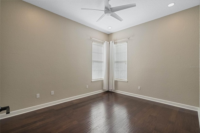 unfurnished room with dark hardwood / wood-style flooring and ceiling fan