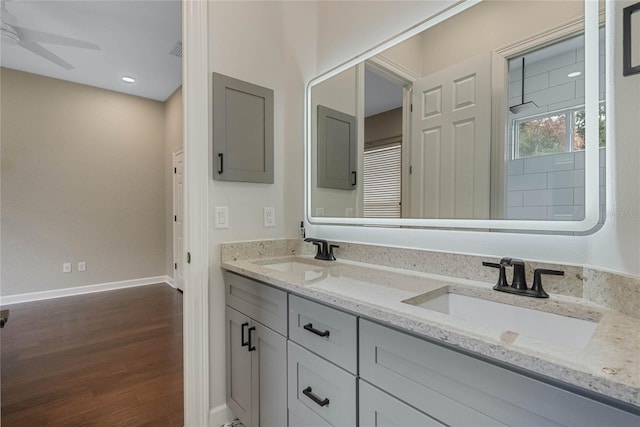 bathroom with hardwood / wood-style flooring, ceiling fan, and vanity