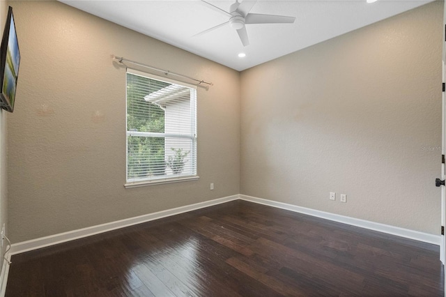 unfurnished room with ceiling fan and dark hardwood / wood-style flooring