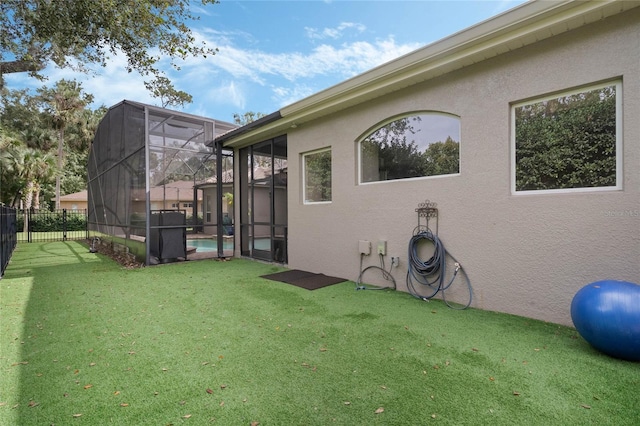 view of yard featuring glass enclosure and a fenced in pool