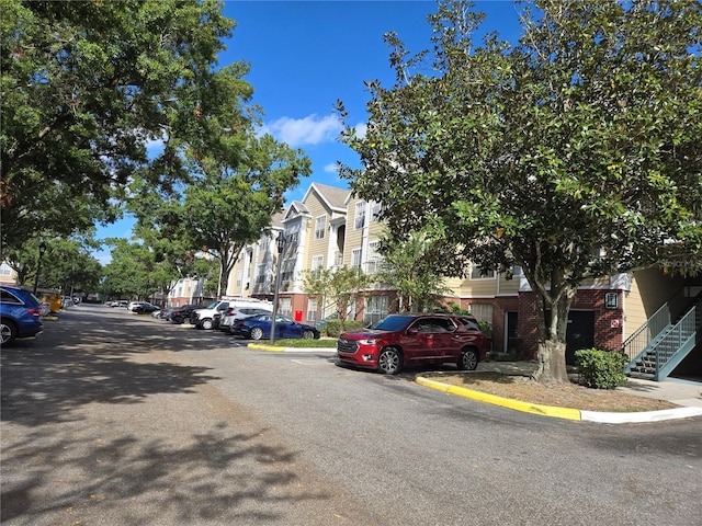 13103 Mulberry Park Dr Unit 817, Orlando, FL 32821 - view of asphalt road featuring curbs and a residential view