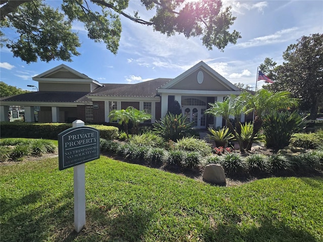 view of front facade with a front lawn and french doors