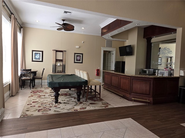 game room with ceiling fan, light hardwood / wood-style floors, billiards, and ornamental molding