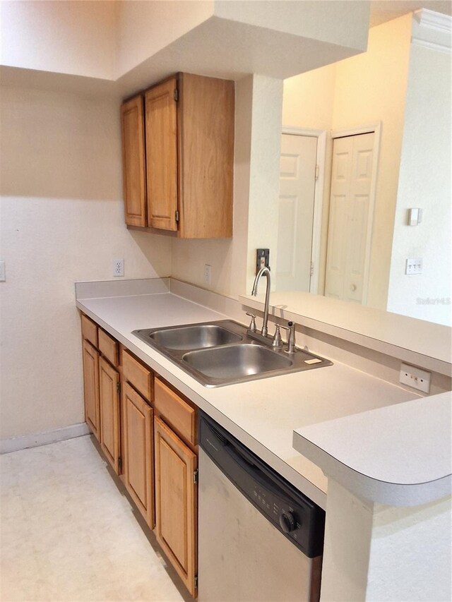 13103 Mulberry Park Dr Unit 817, Orlando, FL 32821 - kitchen with stainless steel dishwasher, light countertops, a peninsula, and brown cabinetry