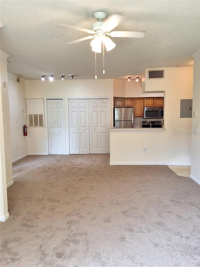 13103 Mulberry Park Dr Unit 817, Orlando, FL 32821 - unfurnished living room with a ceiling fan, a textured ceiling, light colored carpet, and electric panel