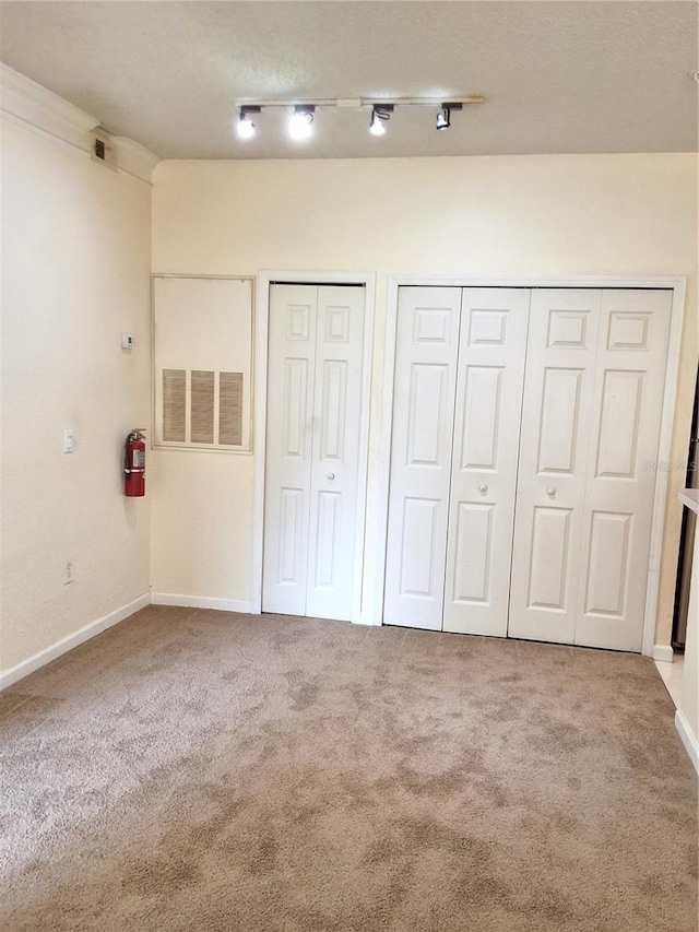 13103 Mulberry Park Dr Unit 817, Orlando, FL 32821 - unfurnished bedroom with multiple closets and carpet flooring