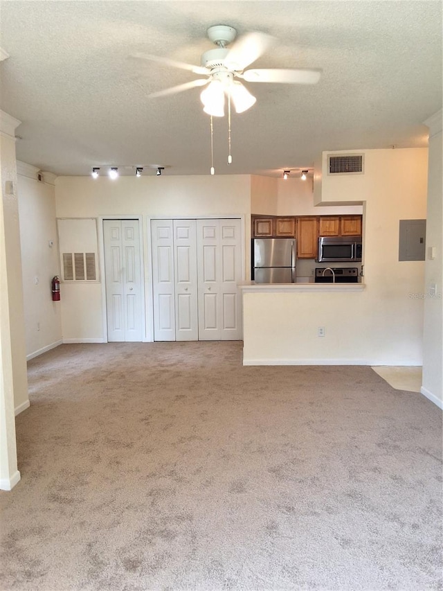 13103 Mulberry Park Dr Unit 817, Orlando, FL 32821 - unfurnished living room featuring a ceiling fan, a textured ceiling, light colored carpet, and electric panel