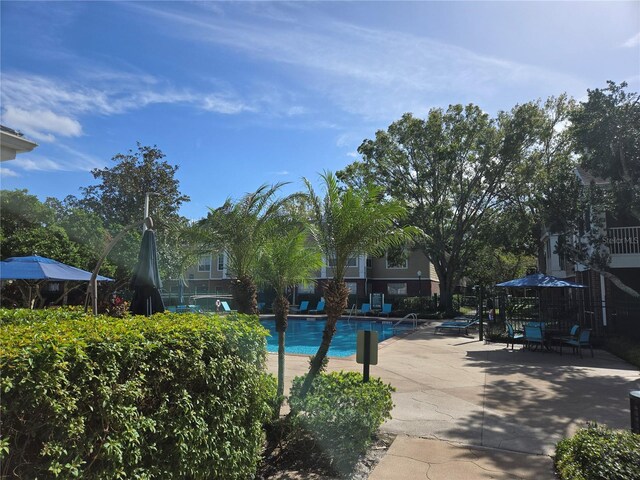 13103 Mulberry Park Dr Unit 817, Orlando, FL 32821 - community pool featuring a patio area