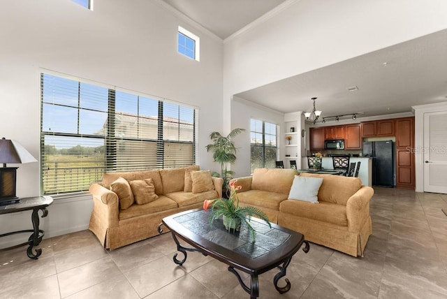 tiled living room featuring ornamental molding and a towering ceiling