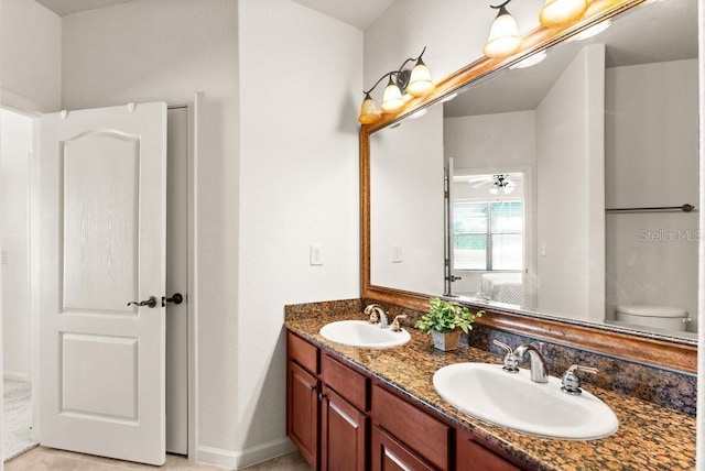 bathroom featuring vanity, ceiling fan, and toilet