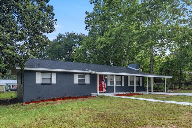 view of front of property featuring a carport and a front lawn