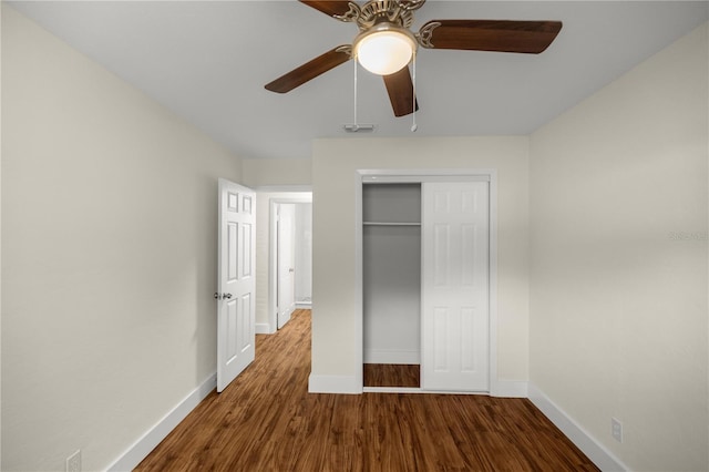 unfurnished bedroom with ceiling fan, a closet, and wood-type flooring