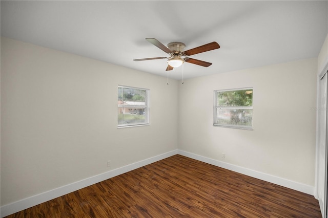 unfurnished room featuring dark hardwood / wood-style floors and ceiling fan