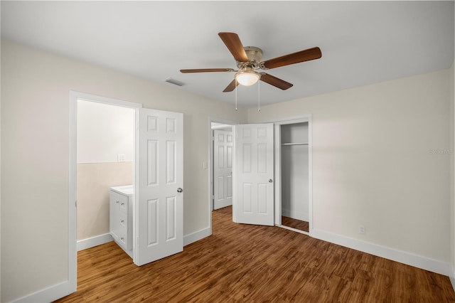 unfurnished bedroom featuring ceiling fan, a closet, and wood-type flooring