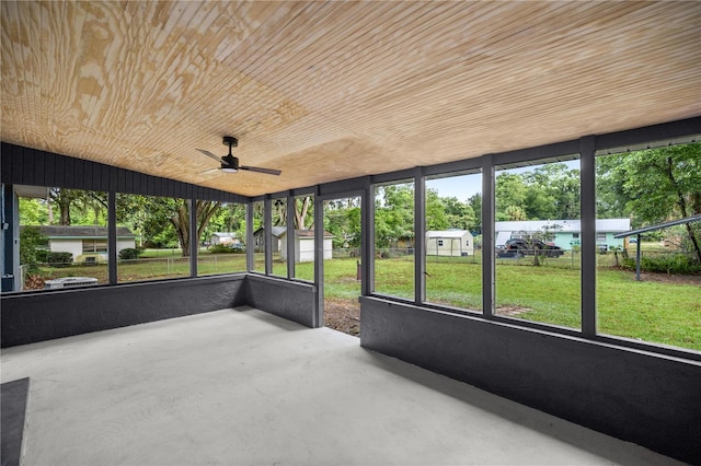 unfurnished sunroom with ceiling fan