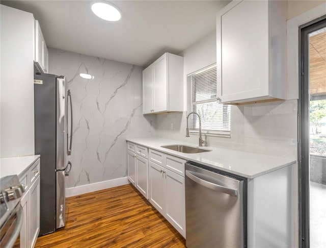 kitchen with white cabinetry, sink, dark hardwood / wood-style floors, and appliances with stainless steel finishes