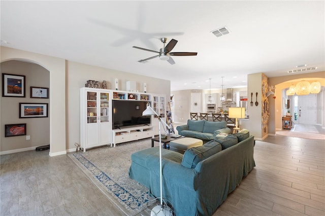 living room featuring ceiling fan and light hardwood / wood-style flooring