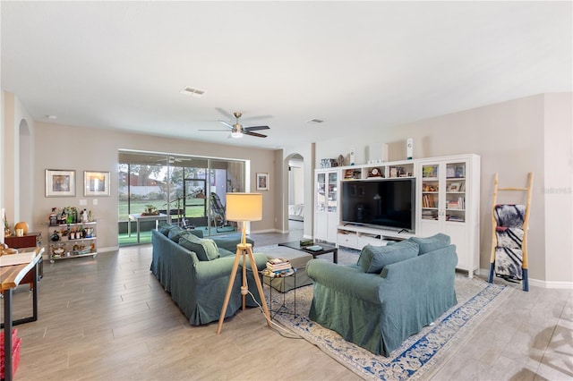 living room with ceiling fan and wood-type flooring