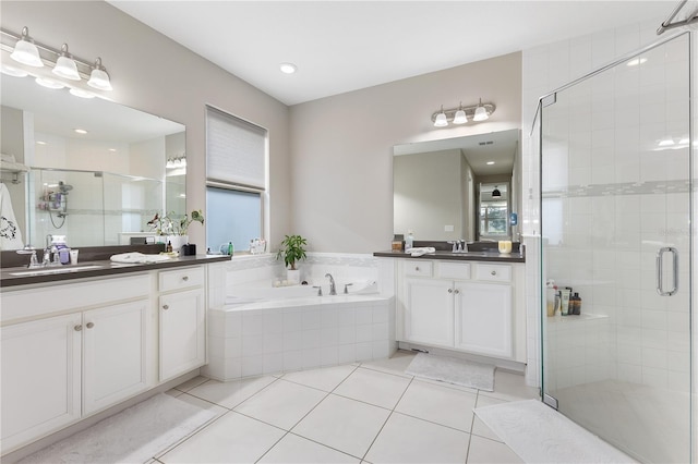 bathroom with tile patterned flooring, vanity, and independent shower and bath