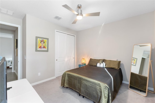 carpeted bedroom with a closet and ceiling fan