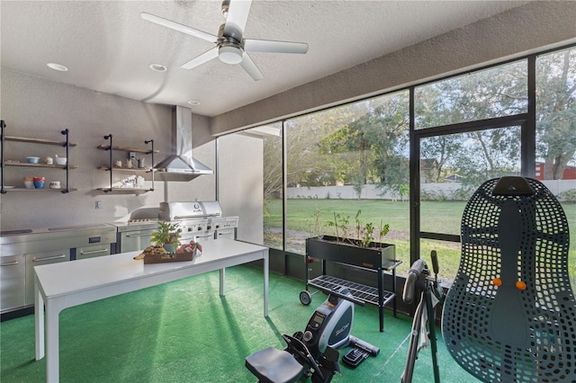 sunroom / solarium featuring ceiling fan