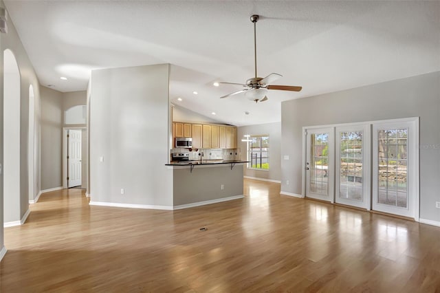 unfurnished living room featuring ceiling fan, high vaulted ceiling, and light hardwood / wood-style flooring