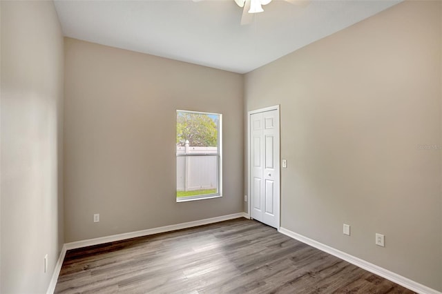 spare room featuring hardwood / wood-style floors and ceiling fan