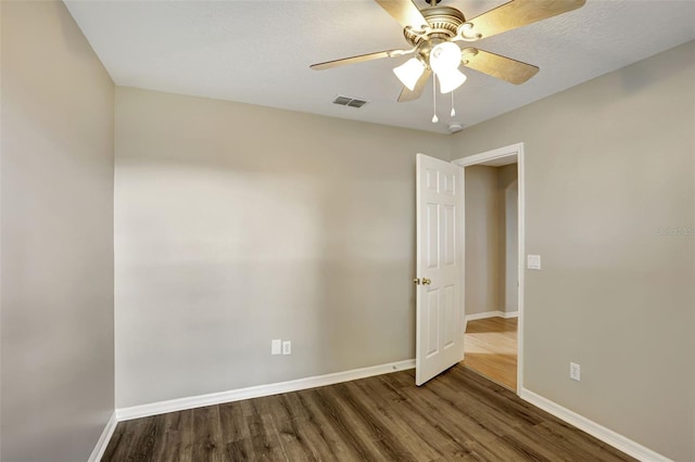 empty room featuring ceiling fan, wood-type flooring, and a textured ceiling