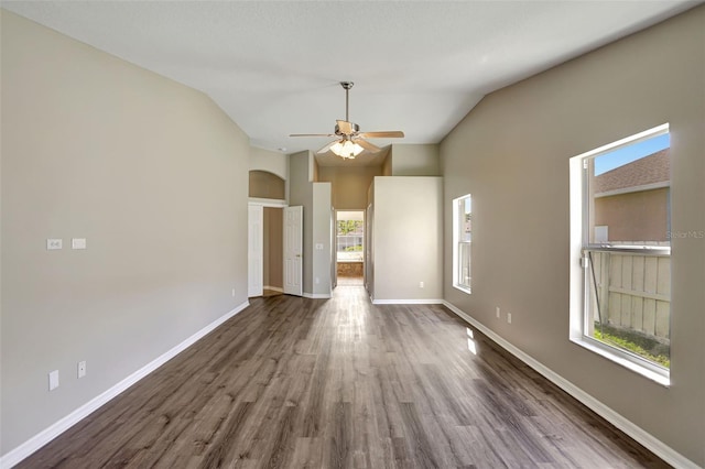 unfurnished room with ceiling fan, dark wood-type flooring, and vaulted ceiling