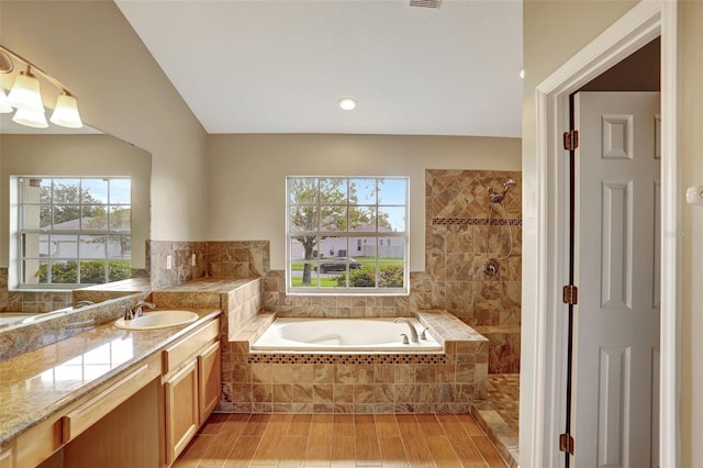 bathroom with vanity, wood-type flooring, and shower with separate bathtub