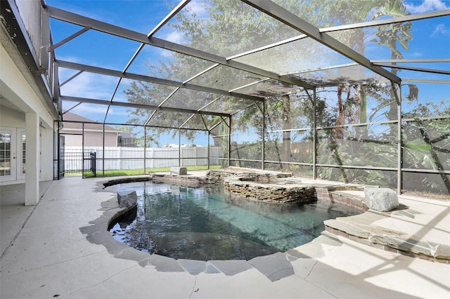 view of pool featuring glass enclosure and a patio