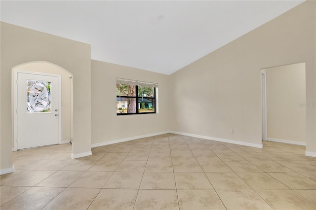 tiled entrance foyer featuring vaulted ceiling