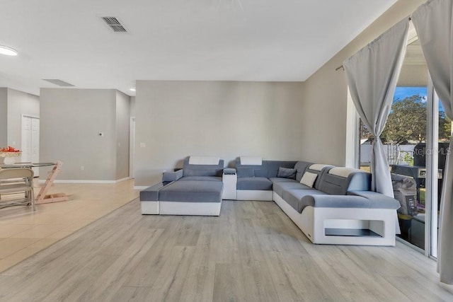 living room with light hardwood / wood-style flooring