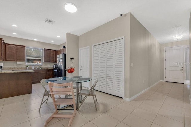 dining room featuring light tile patterned flooring and sink