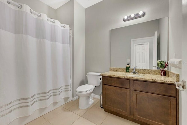 bathroom featuring tile patterned flooring, vanity, toilet, and walk in shower